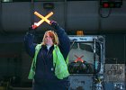 Reflection of My Job - Third Place  Lead Rampserviceperson Sue Blackwell shows perfect technique guiding an inbound aircraft at Chicago’s O’Hare Airport.  Photographer: Donald Peterson, Local Lodge 1487, United Airlines, O’Hare Airport, Chicago, IL